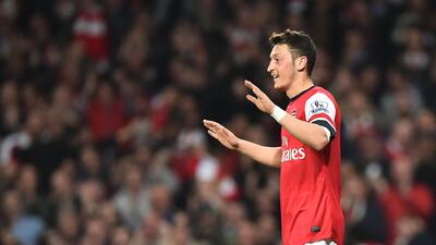Arsenal's German midfielder Mesut Ozil celebrates after scoring his team's second goal during the Premier League match against Newcastle United at the Emirates Stadium in London on April 28, 2014. Ben Stansall / AFP
