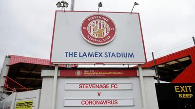 Stevenage, who play in the fourth tier of English football, display a fixture sign at the entrance to their Lamex Stadium showing Stevengage v Coronavirus. Stevenage are among many lower league clubs in England who face an uncertain future due to the pandemic. AP Photo