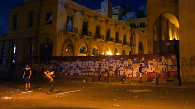 Anti-government protesters hurl stones at Lebanese riot police during a protest against the Lebanese politicians who have ruled the country for decades. EPA