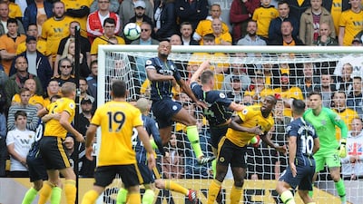 Manchester City's Vincent Kompany, center left, jumps for the ball. AP Photo