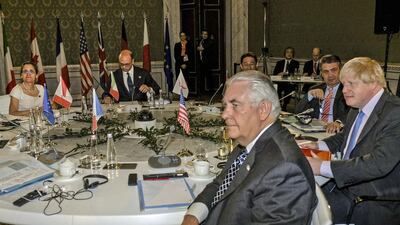 US secretary of state Rex Tillerson, centre front, and British foreign secretary Boris Johnson, far right, sitting together during a meeting of foreign ministers of the G7 in Lucca, Italy on April 11, 2017. Mr Tillerson issued a stark choice to Russia during the meeting, calling on Moscow to choose either alliance with the US and its partners, or choose Assad, Iran and Hizbollah. Riccardo Dalle Luche/ANSA via AP