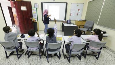 Tagrid Alsuwairi teaches the Arabic class of grade 2 pupils at Al Amal School for the deaf. Jeffrey E Biteng / The National