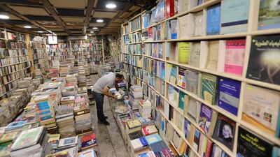 A customer checks books in the shop.