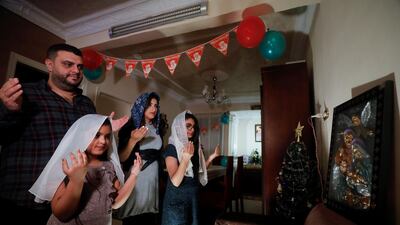 A Coptic family pray during Egypt's Coptic Christmas eve Mass in their home in Shubra El Kheima, Al Qalyubia Governorate, Egypt. Reuters