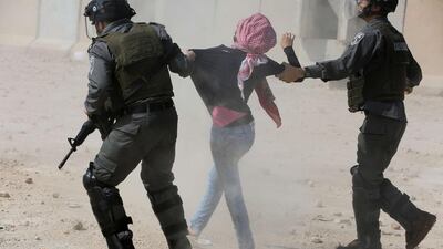 Israeli border guards detain a Palestinian protester during clashes following a demonstration by students from Birzeit University near Ramallah against the incarceration in Israeli jails of Palestinian university students in the West Bank village of Betunia. Abbas Momani / AFP