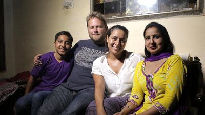 Director John Sammon and producer Nancy Saade, centre, with the wife and son of Arabtec labourer Bikram Singh, whose story is told in the film A Place Called Home. Courtesy Saluki Media