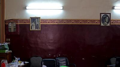 Pictures of King Farouk, son of King Fouad of Egypt (L), and Queen Farida, the first wife of King Farouk (R) hang on a wall at an educational centre in an old building on Fouad street.