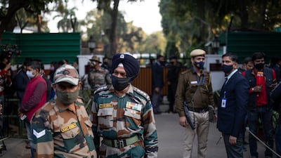 Army personnel and members of the media outside the residence of Gen Bipin Rawat in New Delhi after news of the helicopter accident broke. AP Photo