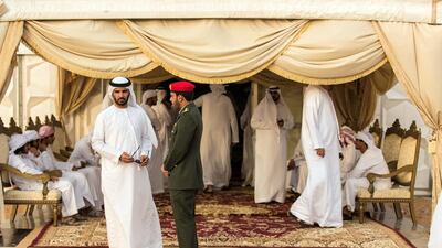 Men gather to pay their respects to the family of Captain Ahmed Khalifa Al Baloushi, 27, a UAE soldier who died in a helicopter crash while serving in Yemen, at a majlis outside the Al Towayya mosque in the Al Towayya area of Al Ain on August 13, 2017. Christopher Pike / The National