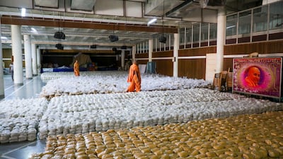 Food supplies and provisions are collected by volunteers and priests from the Baps Swaminarayan Sanstha in Rajkot, western India for Covid-19 patients.