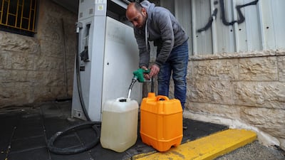 A man fills up at a fuel station in Ramallah, in the Israeli-occupied West Bank on April 2. The IMF and World Bank can help those at the sharp edge of the crisis unfolding around the Strait of Hormuz. AFP