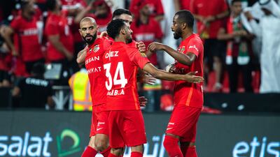 Shabab Al Ahli players celebrate after scoring the opening goal.