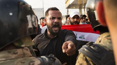 An Iraqi protestor gestures in front of security forces in Basra. AFP