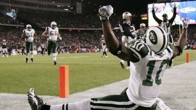 Santonio Holmes, of the Jets, celebrates after scoring a touchdown against the Patriots.