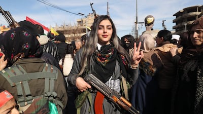 Kurdish civilians gather with their weapons in Qamishli, as the SDF calls for young people to resist a Syrian army takeover. AFP