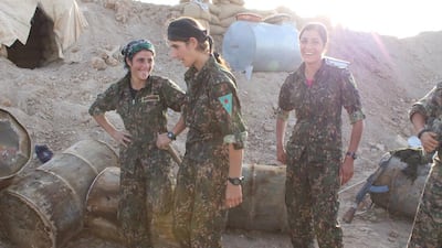 YPG fighters behind the berm that shields them from enemy fire. Florian Neuhof for The National