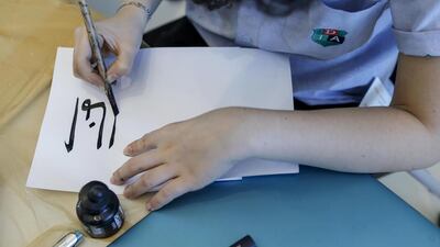 A student in Dubai practices Arabic Calligraphy (Photo: Antonie Robertson)