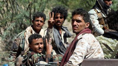 Forces loyal to Yemen's Saudi-backed government flash the victory sign as they deploy west of the country's third-city of Taez, on March 16, 2021. AFP