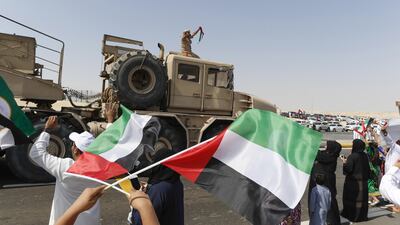 Emiratis celebrating the welcome of the troops held up pictures of sheikhs from around the Emirates, including pictures of the founding president, Sheikh Zayed.