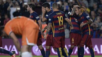 Barcelona players congratulate Neymar after one of his four goals on Saturday night against Rayo Vallecano at the Camp Nou. Josep Lago / AFP