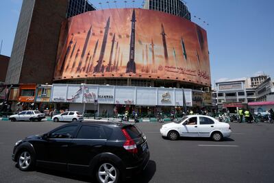 An anti-Israel banner in Tehran depicts missiles being launched, with the US vowing to undermine Iran's military potency. AP