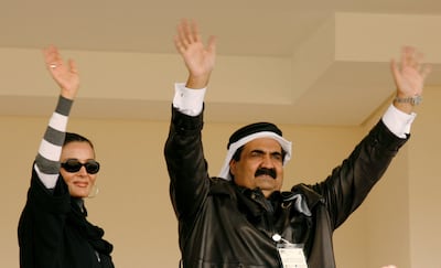 Sheikh Hamad and Sheikha Mozah wave to medal winners during the 15th Asian Games in Doha. Reuters