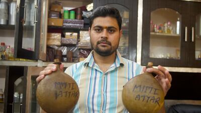 Gaurav Mehrotra, 32, showing perfume stored in traditional containers made of camel skin