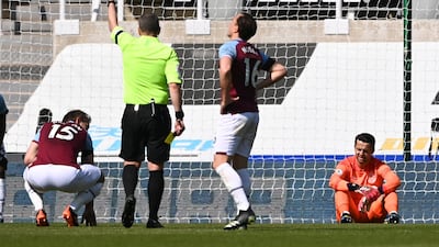 Referee Kevin Friend shows a red card to West Ham's Craig Dawson. AP