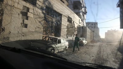 A medic runs for cover during reported regime shelling on the rebel-held town of Hamouria, in the besieged Eastern Ghouta region on the outskirts of the capital Damascus. AFP