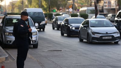 An Iraqi security personnel stands guard along a street in Baghdad on Sunday. Iraqi authorities arrested several officials as part of an anti-graft campaign. AFP