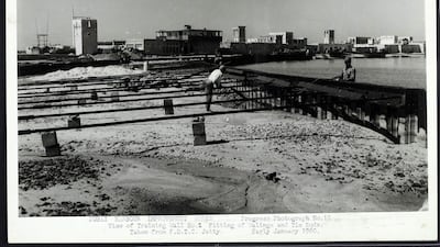 Improvement works at Dubai harbour in 1959/1960. Note the wind towers in the houses along the waterfront. Crown Copyright Images