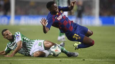 Betis midfielder Alfonso Pedraza challenges Barcelona´s Guinea-Bissau forward Ansu Fati. AFP