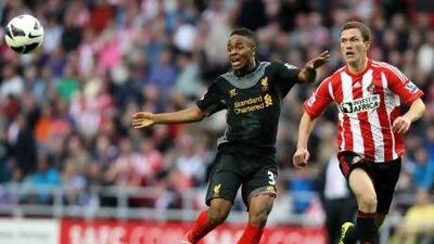 Liverpool's Raheem Sterling, left, vies for the ball with Sunderland's Craig Gardner during their English Premier League match at the Stadium of Light, Sunderland. Scott Heppell / AP Photo