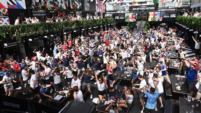 England supporters celebrate as they watch a public viewing of the UEFA EURO 2020 match between England and Croatia, in Boxpark, Croydon. EPA