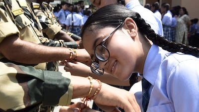 The ritual is meant to protect the brother from evil and cement the bond between a brother and sister. AFP