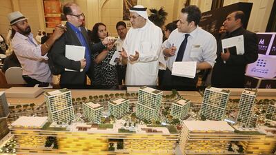 Saeed Al Qatami, CEO of Deyaar Development, next to a scale model of the Midtown development at International Media Production Zone, on display at Shangri-La Hotel in Dubai. Sarah Dea / The National