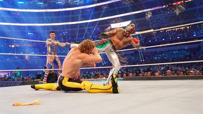 Logan Paul attempts to duck out of the way of Rey Mysterio.