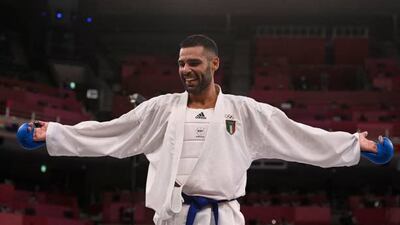 Italy's Luigi Busa celebrates after beating Azerbaijan's Rafael Aghayev in the men's kumite -75kg final of the karate competition.