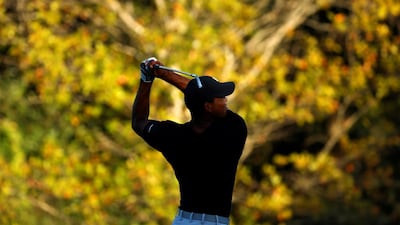 Tiger Woods hits off the fairway on the 5th hole. Reuters