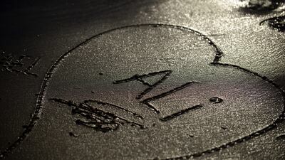 Wael drew a heart with the name of his son Ali in the sand at the Elbe river shore at the harbour in Hamburg. Wael was reunited with his family three weeks ago after Reem and Ali made it to Germany following an arduous journey. Astrid Riecken / Getty Images