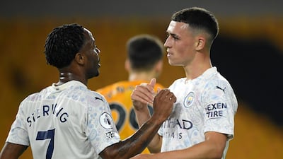 Phil Foden, right, is congratulated by Raheem Sterling after scoring Manchester City's second goal against Wolves. AP Photo