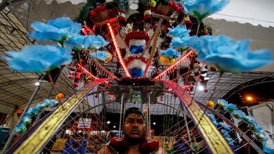 A Hindu devotee carries an LED-illuminated kavadi, or physical burden, at the Sri Srinivasa Perumal Temple during the festival of Thaipusam in Singapore. EPA