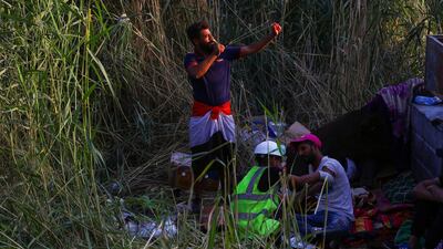 An Iraqi demonstrator uses a sling shot under Al Jumhuriya bridge during the ongoing anti-government protests in Baghdad, Iraq. Reuters