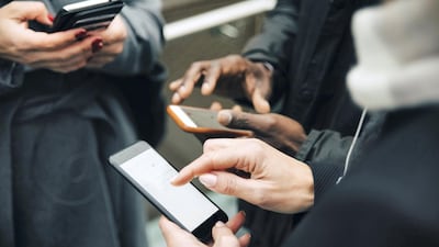 A common sight: browsing social media on phones at the cost of real human interactions. Getty