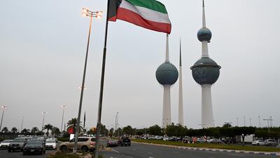 The Kuwaiti flag flying in Kuwait City. The government has cancelled events to mark National Day and Liberation Day, on February 25 and 26, to curb the spread of Covid-19. EPA