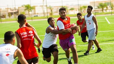 Young payers from Hamden bin Rashed High School in a training session with Ben Ryan and Chris Cracknell. Courtesy HSBC Youth Rugby