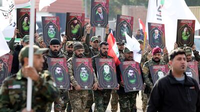 Members of the Popular Mobilisation Forces carry images of comrades killed in US air strikes in western Iraq, at a funeral procession in Baghdad. EPA