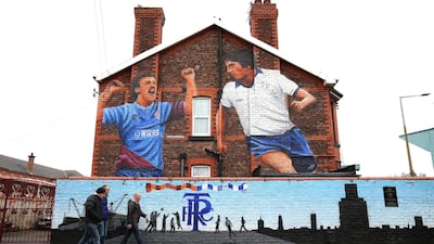 Fans walk past a mural near Tranmere Rovers' ground Prenton Park in Birkenhead, England, ahead of their League One football match against Wycombe Wanderers on Sunday, November 17.