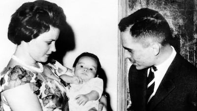 King Hussein and his first wife Queen Mona look at their eldest son Abdallah in Amman. AFP