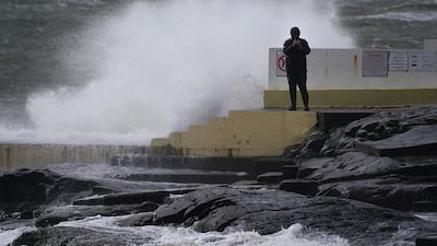 A man takes photos of the waves at Blackrock Diving Board, Salthill, County Galway, Northern Ireland. PA